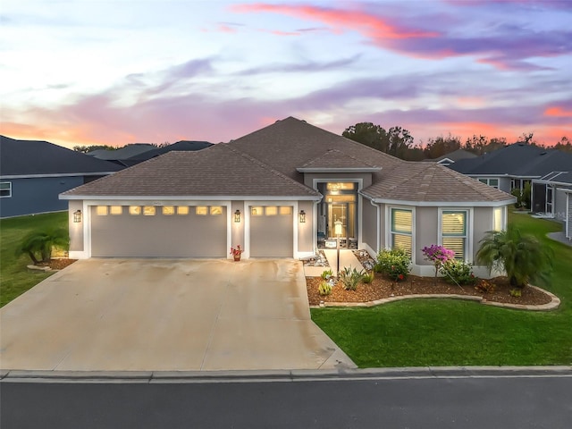 view of front facade featuring a garage and a lawn