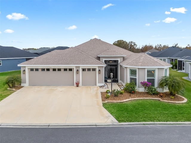 view of front of home featuring a front yard and a garage