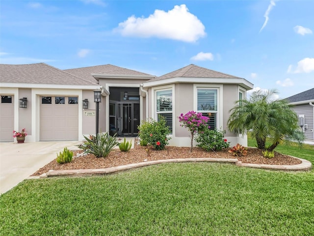 view of front of property featuring a front lawn and a garage