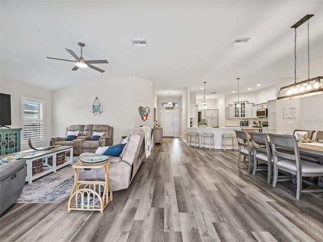 living room featuring ceiling fan and hardwood / wood-style floors