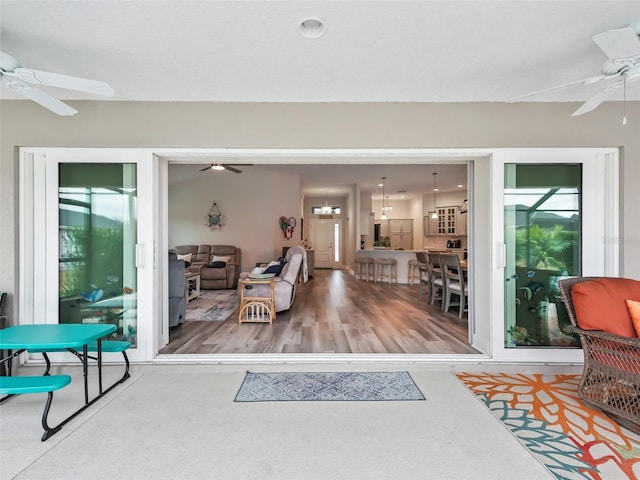 interior space with a healthy amount of sunlight and ceiling fan with notable chandelier