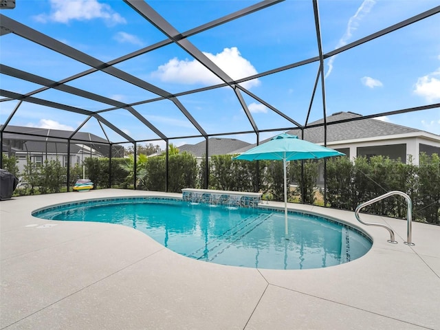 view of pool with a lanai, pool water feature, and a patio