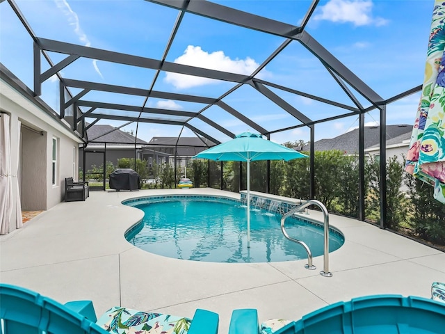 view of swimming pool with pool water feature, a patio, and a lanai