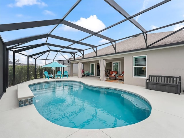 view of swimming pool with ceiling fan, glass enclosure, and a patio area