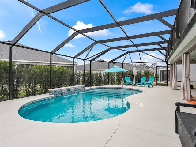 view of pool with a lanai, pool water feature, and a patio