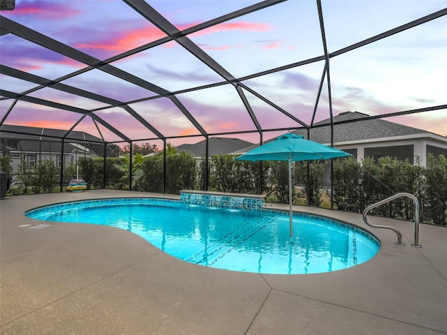 pool at dusk featuring a lanai, pool water feature, and a patio area