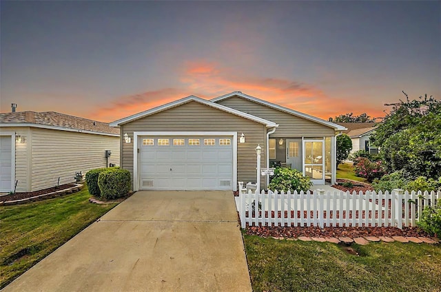 view of front of home featuring a lawn and a garage