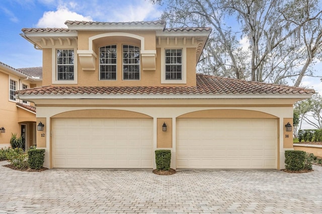 mediterranean / spanish-style house with a garage