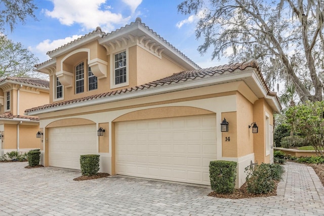 mediterranean / spanish-style home with a garage