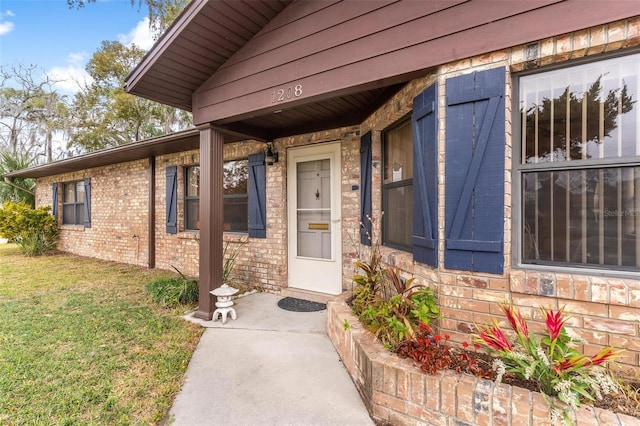 doorway to property featuring a yard