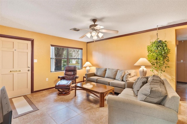 living room with ceiling fan, ornamental molding, and a textured ceiling