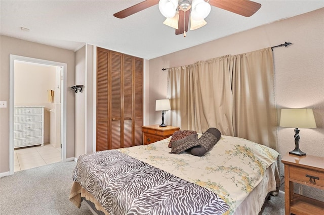 carpeted bedroom featuring ceiling fan and a closet