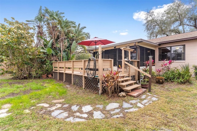 view of yard featuring a deck and a sunroom