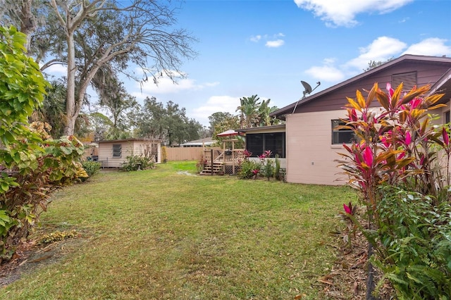 view of yard with a storage shed and a wooden deck