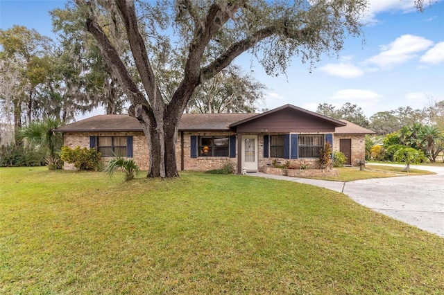 ranch-style house with a front lawn and brick siding