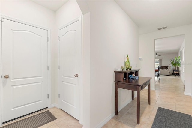 foyer with ceiling fan and light tile patterned floors