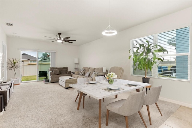 tiled dining room featuring ceiling fan