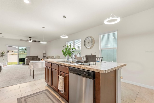 kitchen featuring dishwasher, decorative light fixtures, a center island with sink, and light carpet