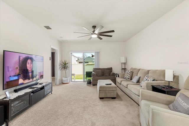 carpeted living room with ceiling fan