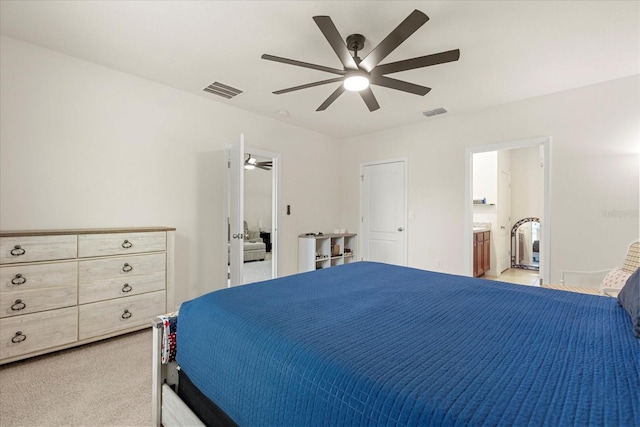 carpeted bedroom featuring ceiling fan and ensuite bathroom