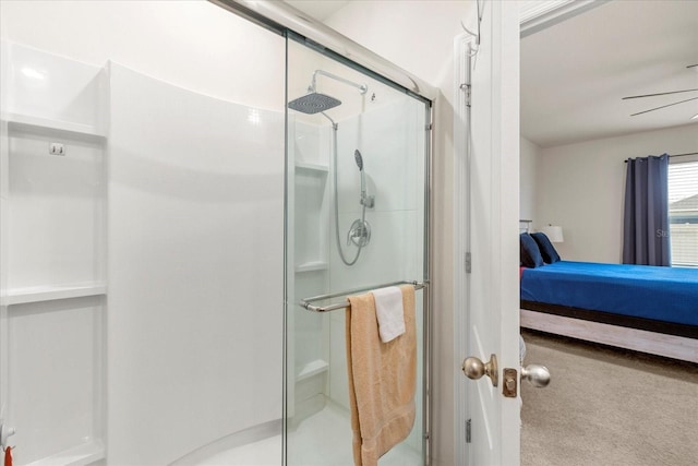 bathroom featuring a shower with shower door and ceiling fan