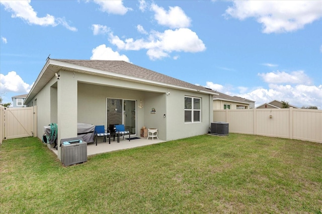 back of house featuring central AC unit, a patio, and a lawn