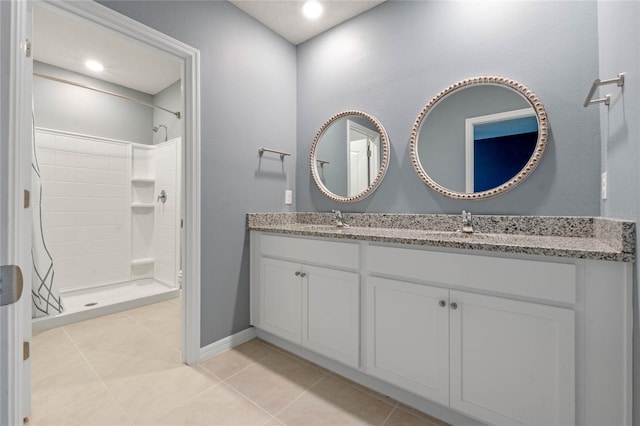 bathroom featuring a shower, tile patterned flooring, and vanity