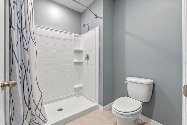 bathroom with toilet, tile patterned flooring, and walk in shower