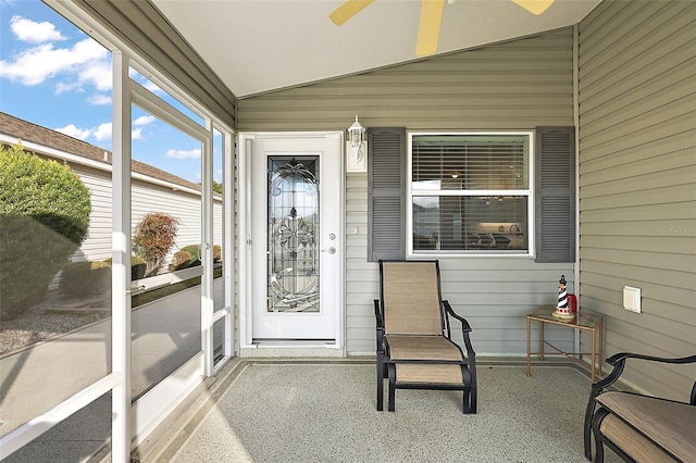 sunroom / solarium featuring ceiling fan and lofted ceiling