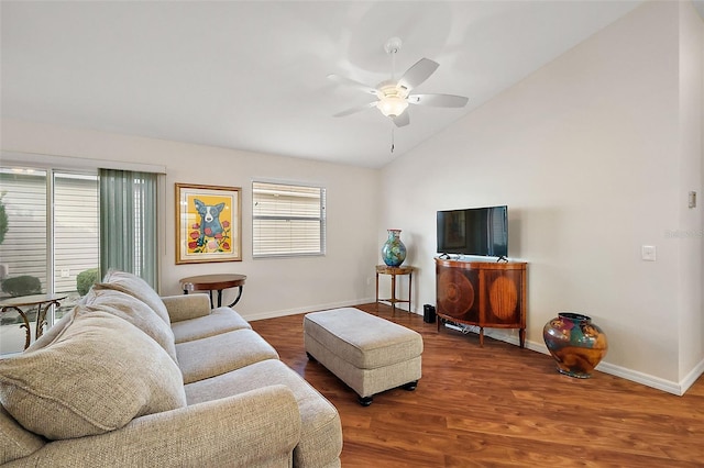 living room with lofted ceiling, ceiling fan, a wealth of natural light, and hardwood / wood-style flooring