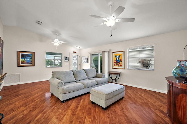 living room with ceiling fan, dark hardwood / wood-style floors, and vaulted ceiling