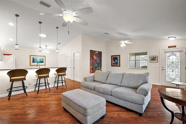 living room with vaulted ceiling, dark wood-type flooring, and sink