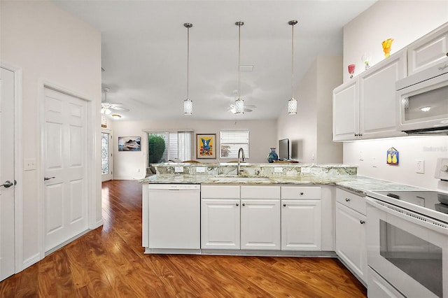 kitchen with white cabinets, kitchen peninsula, sink, and white appliances