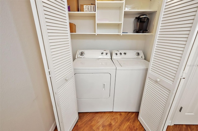 laundry room featuring washing machine and dryer and hardwood / wood-style floors