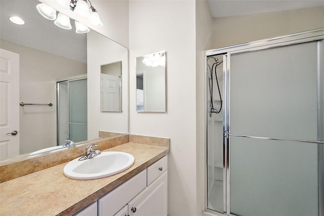 bathroom featuring walk in shower and vanity