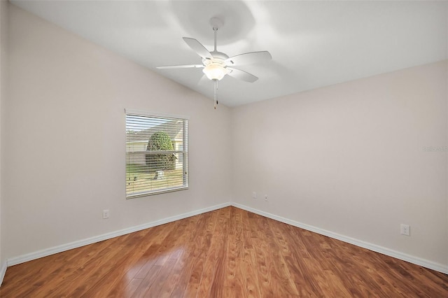 unfurnished room featuring hardwood / wood-style flooring, ceiling fan, and vaulted ceiling