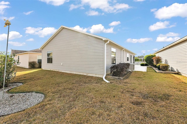 view of side of property with a lawn