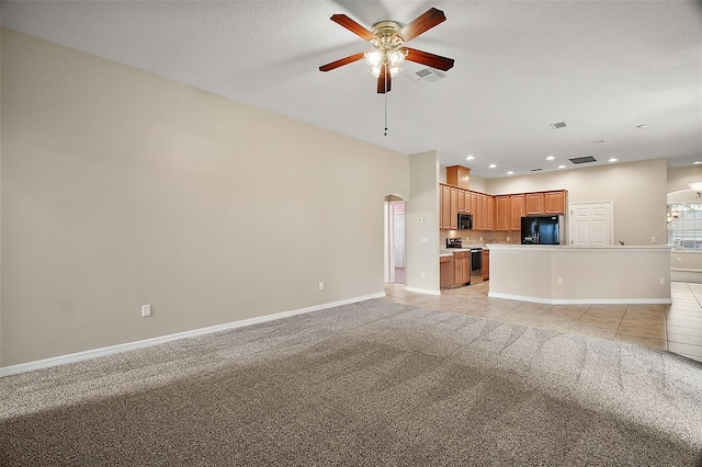 unfurnished living room featuring ceiling fan and light carpet