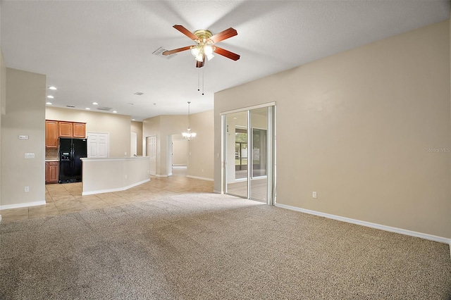 unfurnished living room featuring ceiling fan with notable chandelier and light colored carpet