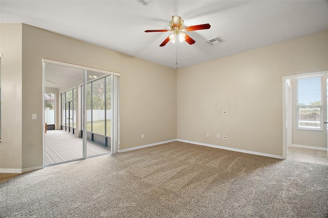 carpeted empty room featuring ceiling fan