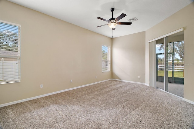 spare room with ceiling fan, a healthy amount of sunlight, and carpet