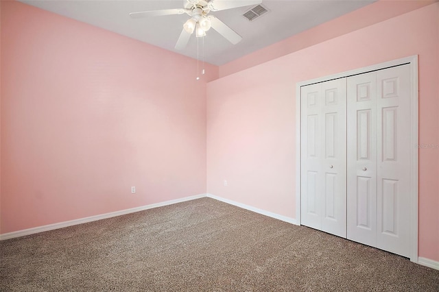 unfurnished bedroom with ceiling fan, a closet, and carpet floors