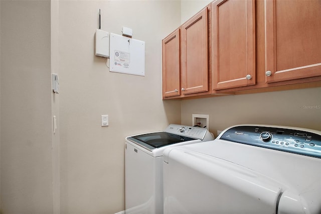 washroom with cabinets and independent washer and dryer