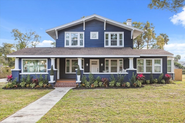 view of front of house featuring covered porch and a front lawn