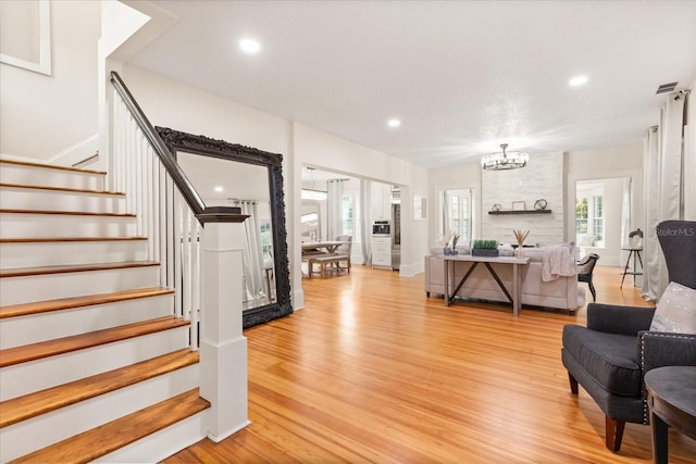 living room featuring an inviting chandelier and light wood-type flooring