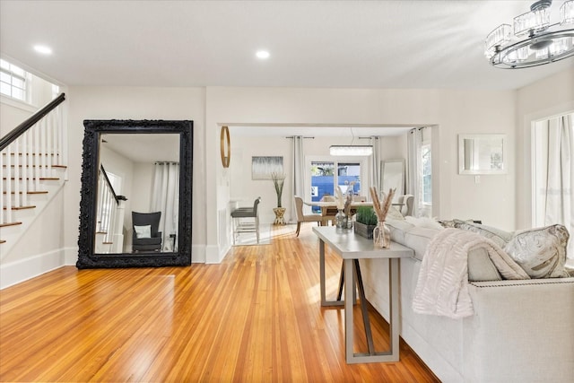 living room featuring a chandelier, hardwood / wood-style flooring, and plenty of natural light