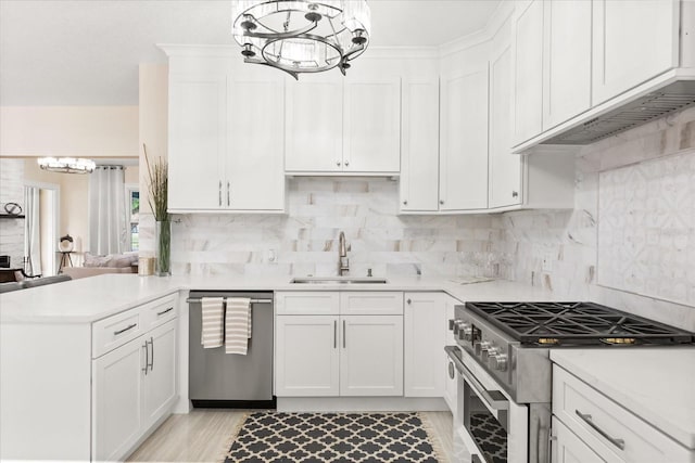 kitchen with appliances with stainless steel finishes, white cabinets, and sink