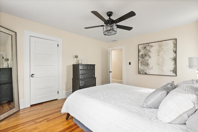 bedroom with hardwood / wood-style floors and ceiling fan