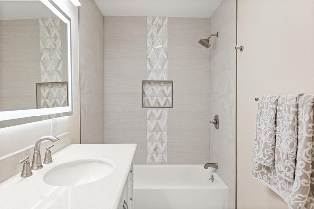 bathroom with vanity and tiled shower / bath combo