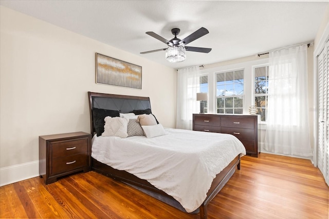 bedroom with wood-type flooring and ceiling fan